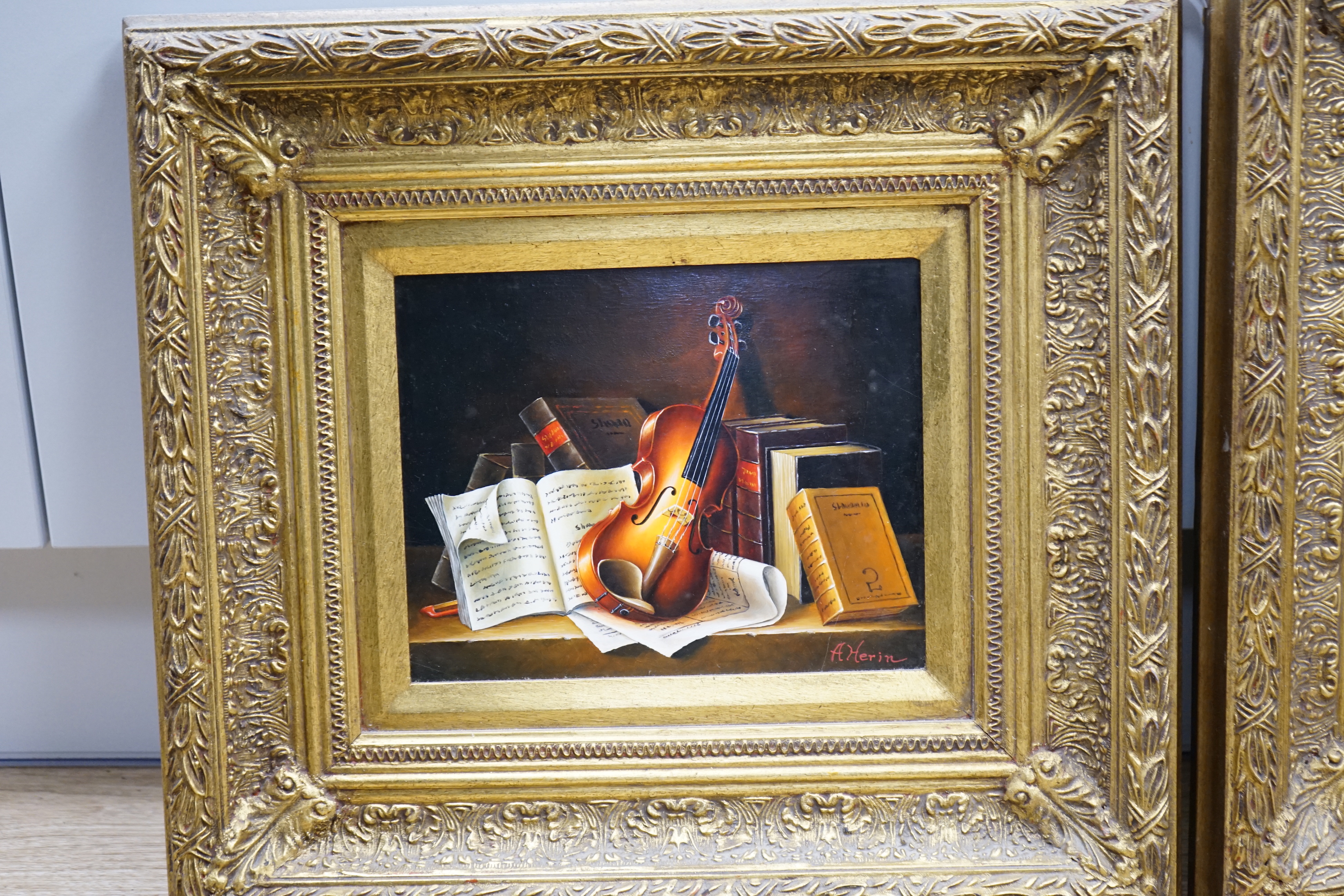 A Herin, set of three contemporary oils on board, Still lifes of musical instruments and sheet music, two signed, each 19 x 24cm, ornate gilt framed